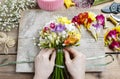 Florist at work. Woman making bouquet of freesia flowers Royalty Free Stock Photo
