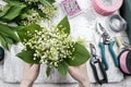 Florist at work. Woman making bouquet of lily of the valley flow