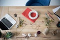 Florist workplace with dry flowers, wreath and laptop in modern office