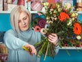 Florist in the workplace. Flower shop. Portrait of a smiling woman Royalty Free Stock Photo