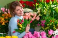 Florist in the workplace. Flower shop. Portrait of a smiling beautiful woman Royalty Free Stock Photo