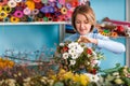 Florist in the workplace. Flower shop. Portrait of a smiling beautiful woman Royalty Free Stock Photo