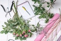 Florist workplace: flowers, accessories, tools and a notebook for records. Top view Royalty Free Stock Photo