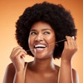 Flossing, dental and black woman cleaning teeth against an orange studio background. Young, African and thinking model Royalty Free Stock Photo