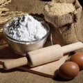 Flour in bowl, eggs, rice and rolling pin