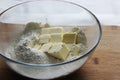 Flour and butter cubes in a large glass bowl. Homemade cake. Housework