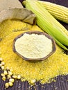 Flour corn in bowl with grits on dark board