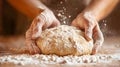 Flour-dusted hands shaping dough in a rustic baking setting Royalty Free Stock Photo