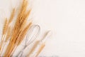 Flour and ears of wheat, barley, cooking, bread, and cookies are arranged on the table in a rustic kitchen, top view Royalty Free Stock Photo