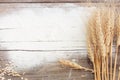 Flour and ears of wheat, barley, cooking, bread, and cookies were arranged on the wooden table background in a rustic kitchen. Top Royalty Free Stock Photo