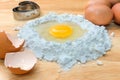 Flour with egg and ingredients for homemade bakery on wooden background Royalty Free Stock Photo