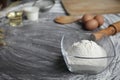 Flour, egg, olive oil, milk, wheat ears, kitchen tool on gray table background Royalty Free Stock Photo