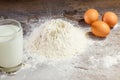 Flour and eggs, cooking dough. The recipe for cooking pizza, pasta, bread. House cooking from the chef. Wooden background