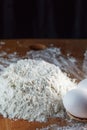 Flour and eggs are prepared for kneading dough, on a wooden background Royalty Free Stock Photo