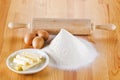 Flour with eggs, rolling pin and butter Royalty Free Stock Photo