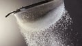 Flour falling through a metal sieve