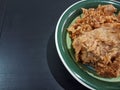 Flour fried chicken in a bowl on a black background