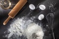 Flour and ingredients on black table Royalty Free Stock Photo