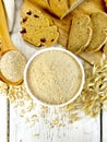 Flour oat in white bowl with bran in spoon on board top