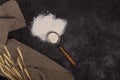 Flour in a plate with a flour scoop. The texture of the black background. Ears of wheat Royalty Free Stock Photo