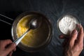 Flour is poured into a saucepan with melted butter close-up Royalty Free Stock Photo