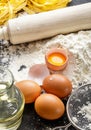 Flour, rolling pin and raw egg yolk