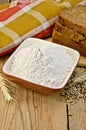 Flour rye in a bowl with bread and ears rye Royalty Free Stock Photo