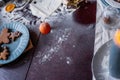 Flour is scattered on wooden Christmas table, gingerbread cookies are being baked. New Years flatlay