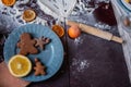 Flour is scattered on wooden Christmas table, gingerbread cookies are being baked. New Years flatlay