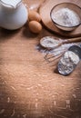 Flour in scoop spoon and bowl eggs pitcher milk on