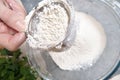 Flour is sieved with a metal sieve Royalty Free Stock Photo