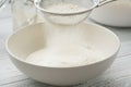 Flour sifting through a sieve for a baking Royalty Free Stock Photo