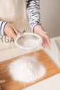 Flour sifting through a sieve for a baking