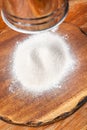 flour sifting through sifter on wooden board