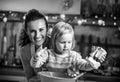 Flour smeared mother and baby making christmas cooki