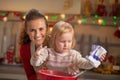 Flour smeared mother and baby making cookies