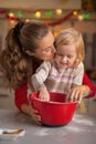 Flour smeared mother and baby making cookies