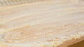 Flour on a wooden cutting board