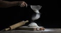 Flour is sprinkled over a ball of dough on a wooden board with r Royalty Free Stock Photo