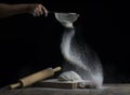 Flour is sprinkled over a ball of dough on a wooden board with r Royalty Free Stock Photo