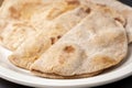 Flour tortillas with bran on a white plate close-up