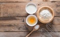 The flour in a wooden bowl, egg, milk and whip for beating. Royalty Free Stock Photo