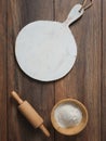 Flour, wooden rolling pin and beautiful white round cutting board. Empty template for design Royalty Free Stock Photo