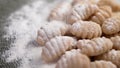 Flouring raw homemade gnocchi pasta in slow motion. Type of Italian lunch.