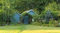 Flourishing farm backyard with sheds and garden house Royalty Free Stock Photo