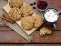 Flourless gluten free peanut butter, oatmeal, honey, dried fruits cookies and cup of cocoa with marshmallows on wooden background.