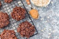 Flourless no bake peanut butter and oatmeal chocolate cookies on cooling rack, horizontal, top view, copy space