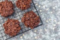 Flourless no bake peanut butter and oatmeal chocolate cookies on a cooling rack, horizontal, top view, copy space