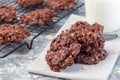 Flourless no bake peanut butter and oatmeal chocolate cookies with glass of milk, horizontal