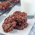 Flourless no bake peanut butter and oatmeal chocolate cookies with glass of milk, square format